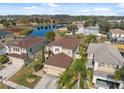 Aerial view of home showcasing backyard, landscaping and a nearby pond at 18819 Sunterra Dr, Land O Lakes, FL 34638