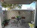 Tranquil condo balcony with outdoor chairs, table, plants, and decor at 12408 Eagleswood Dr # B, Hudson, FL 34667