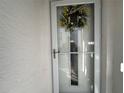 Close up of condo front door decorated with wreath at 12408 Eagleswood Dr # B, Hudson, FL 34667