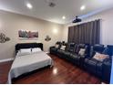 Cozy bedroom setup with a Murphy bed, projector, and cinema seating, perfect for movie nights at 1421 Apollo Beach Blvd, Apollo Beach, FL 33572