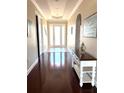 Inviting entryway features hardwood floors and elegant decor, leading into a bright and welcoming home at 1421 Apollo Beach Blvd, Apollo Beach, FL 33572
