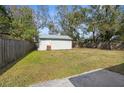 Large backyard with a storage shed and a fully fenced perimeter, offering ample outdoor space at 1709 W Dempsey Ave, Tampa, FL 33603