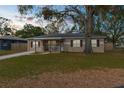 Charming single-story home features a front porch, well-maintained lawn, and mature shade tree at 1709 W Dempsey Ave, Tampa, FL 33603
