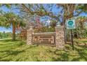 Entrance to Hammock Park, featuring stone pillars and directional signage at 1888 Douglas Ave, Dunedin, FL 34698