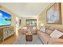 Cozy living room featuring neutral decor, comfortable seating, and a modern entertainment setup at 3038 Eastland Blvd # F103, Clearwater, FL 33761
