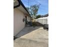 Property exterior featuring a fenced-in yard, concrete slab and ev charger at 4115 Corn St, Port Charlotte, FL 33948
