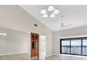 Bright living room featuring wood floors, mirrored wall, ceiling fan, and sliding door access to the lanai at 4620 Bay Blvd # 1154, Port Richey, FL 34668
