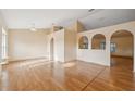Open-concept living area with light walls, wood-look floors and decorative archways at 5155 Baldock Ave, Spring Hill, FL 34608