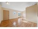 Bright room featuring high ceilings, wood-look flooring, and a unique round window at 5155 Baldock Ave, Spring Hill, FL 34608