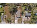 Overhead view of the property featuring a fenced yard, gravel driveway, and cozy home at 9250 Peony St, New Port Richey, FL 34654