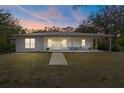 Charming single-story home with a metal roof, a covered porch, and manicured front lawn at 16411 County Road 675, Parrish, FL 34219