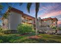 Well-maintained exterior of a multi-story building featuring balconies and neat landscaping at 1723 Gulf Rd # 104, Tarpon Springs, FL 34689