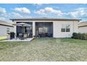 Spacious backyard with a screened-in lanai and a patio area, perfect for outdoor entertaining and relaxation at 18629 Coastal Shore Ter, Land O Lakes, FL 34638