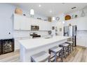 Modern kitchen with white cabinets, stainless steel appliances, large island, and seating, perfect for Gathering gatherings at 18629 Coastal Shore Ter, Land O Lakes, FL 34638