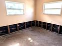 Bedroom walls and floors have been cleared with the drywall cutaway to reveal studs and wiring at 222 84Th N Ave, St Petersburg, FL 33702