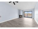 Open-concept living room with a fireplace and sliding glass doors to the balcony at 2440 Winding Creek Blvd # 305, Clearwater, FL 33761