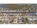 An aerial view of a neighborhood featuring waterfront homes and beautiful canal views at 4007 Floramar Ter, New Port Richey, FL 34652