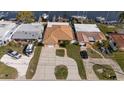 An aerial view of the home showing a lush, green lawn, convenient driveway, and surrounding neighborhood at 4007 Floramar Ter, New Port Richey, FL 34652