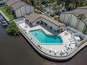 Aerial view of community pool overlooking the river, complete with seating at 432 Moorings Cove Dr. # 432, Tarpon Springs, FL 34689