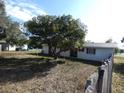 Image shows home's backyard and fence on a sunny day at 4451 Higate Rd, Spring Hill, FL 34609