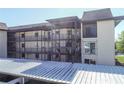 Condo featuring multiple stories, covered parking, and walkways to unit entrances at 4452 Garnet Dr # 101, New Port Richey, FL 34652