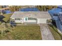 An overhead view shows a waterfront home with a tile roof and lush green lawn at 5122 Bonito Dr, New Port Richey, FL 34652