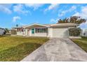 Well-maintained single-Gathering home with a two-car garage and lush front lawn at 5122 Bonito Dr, New Port Richey, FL 34652