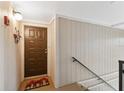 Warm entryway featuring a mushroom-themed rug and wood-paneled walls at 6002 Laketree Ln # L, Temple Terrace, FL 33617