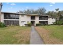 Inviting exterior view of the condo building with well-maintained lawn and landscaping at 6002 Laketree Ln # L, Temple Terrace, FL 33617
