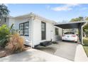 Well-kept home with a convenient carport, black-framed windows and a black front door at 6305 S Macdill Ave, Tampa, FL 33611