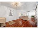Bright living room with hardwood floors, modern lighting, and a charming front door at 6305 S Macdill Ave, Tampa, FL 33611