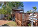 Outdoor structure featuring a covered gazebo with a deck and signage pointing to various outdoor areas at 7235 Maryland Ave, Hudson, FL 34667