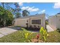 Charming home features an attached garage, neutral paint, manicured lawn and a sidewalk leading to the front door at 7514 Rocky Point Dr, Hudson, FL 34667