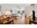 Bright living room with hardwood floors and large windows and access to dining area at 7546 St Andrews Blvd, Weeki Wachee, FL 34613