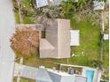 Aerial view of the home showcasing the backyard, including a swimming pool and outdoor lounging area at 7810 Putnam Cir, New Port Richey, FL 34655
