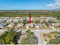 Community aerial shot shows lush green landscaping, mature trees, and neighborhood streets on a bright, sunny day at 8447 Pavilion Dr, Hudson, FL 34667