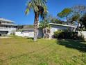 Charming single-story home with a well-manicured front lawn and mature landscaping in a desirable neighborhood at 103 Carlyle Dr, Palm Harbor, FL 34683