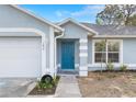 Close up of front door and a well-manicured lawn at 1474 Godfrey Ave, Spring Hill, FL 34609