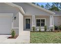 Close up of charming home exterior featuring a well-manicured lawn and inviting front entrance at 18020 Macek Rd, Weeki Wachee, FL 34614