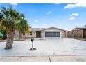 Charming single-story home with palm tree, gray accent, and a spacious driveway leading to a screened-in two-car garage at 3736 Sail Dr, New Port Richey, FL 34652