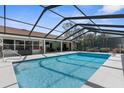 Inviting screened-in pool area with ample seating, providing the perfect outdoor retreat at 4603 Lake In The Woods Dr, Spring Hill, FL 34607