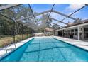 Beautiful screened-in pool with an attached spa and plenty of room for entertaining at 4603 Lake In The Woods Dr, Spring Hill, FL 34607