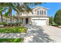 Charming two-story home featuring a well-maintained lawn, a two-car garage, and a welcoming front porch at 5412 Hammock View Ln, Apollo Beach, FL 33572