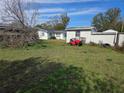 Expansive backyard with ample green space and a shed at 5900 Beech St, Zephyrhills, FL 33542