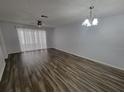 Spacious living room featuring new floors, ceiling fan, and lots of natural light at 3233 Teeside Dr, New Port Richey, FL 34655