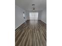 Spacious living room featuring new floors, ceiling fan, and lots of natural light at 3233 Teeside Dr, New Port Richey, FL 34655