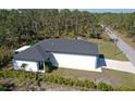 Aerial view of a home showcasing its clean white exterior and newly installed roof at 435 Mcdill Dr, Port Charlotte, FL 33953
