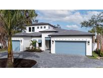 Two-story home with light-colored walls, gray roof, and a two-car garage at 1625 Hansen St, Sarasota, FL 34231