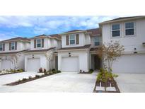 Two-story townhouses with attached garages and landscaping at 11936 Sky Acres Ter, Bradenton, FL 34211