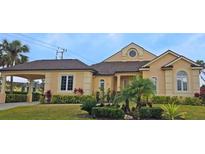 Tan one-story house with covered entry and landscaping at 4415 Barracuda Dr, Bradenton, FL 34208